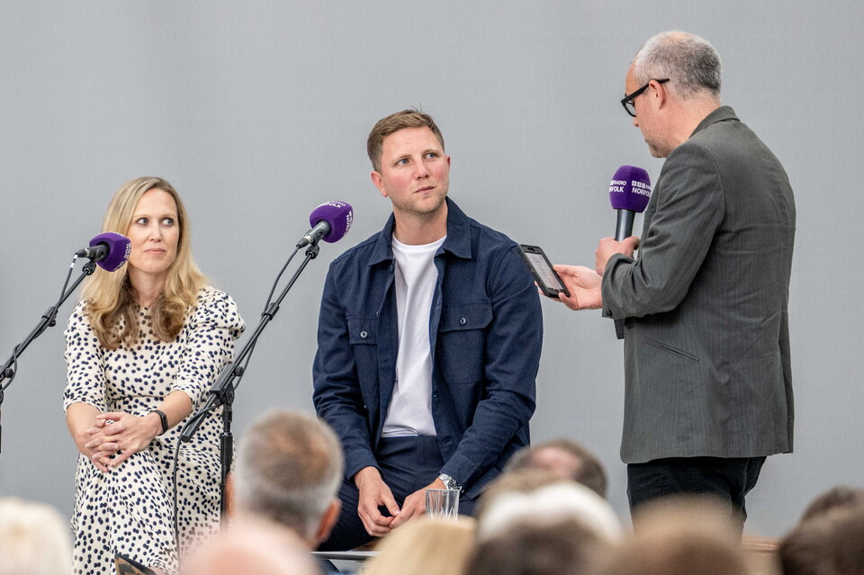 Zoe Webber and Ben Knapper on stage with BBC Radio Norfolk's Chris Goreham