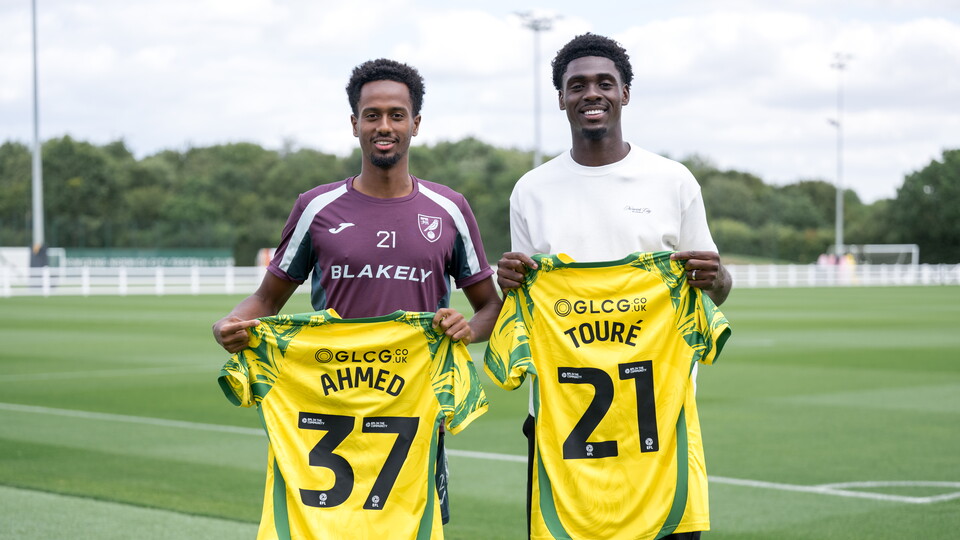 Mo Touré and Ali Ahmed holding shirt