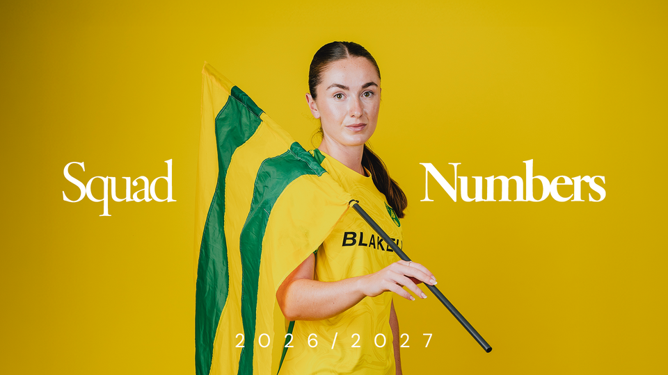 Grace Riglar wearing the home kit holding a flag