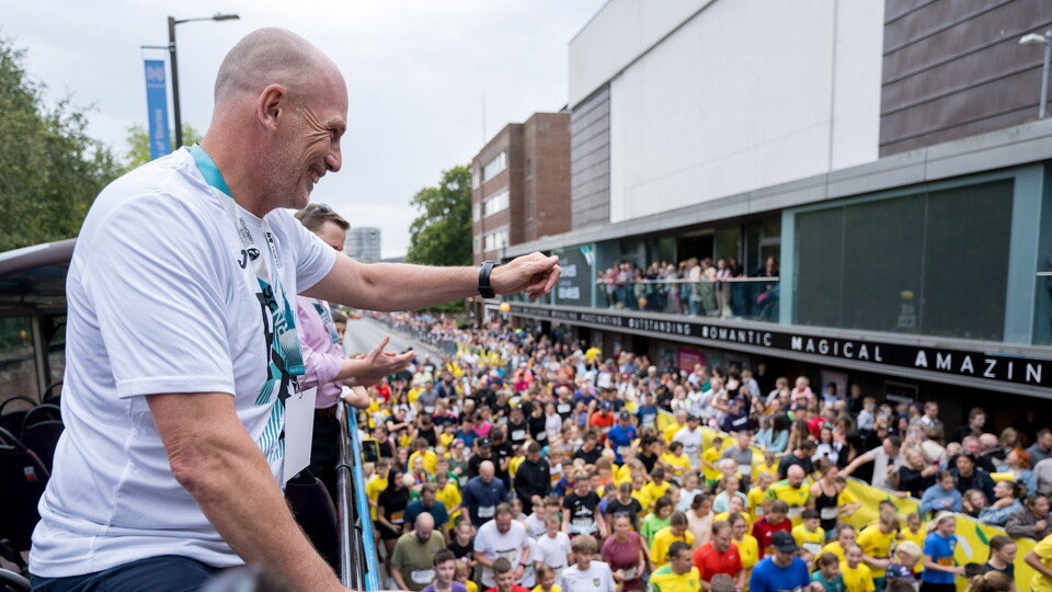 Philippe Clement as the official race starter for Run Norwich 2026 on top of a double decker bus