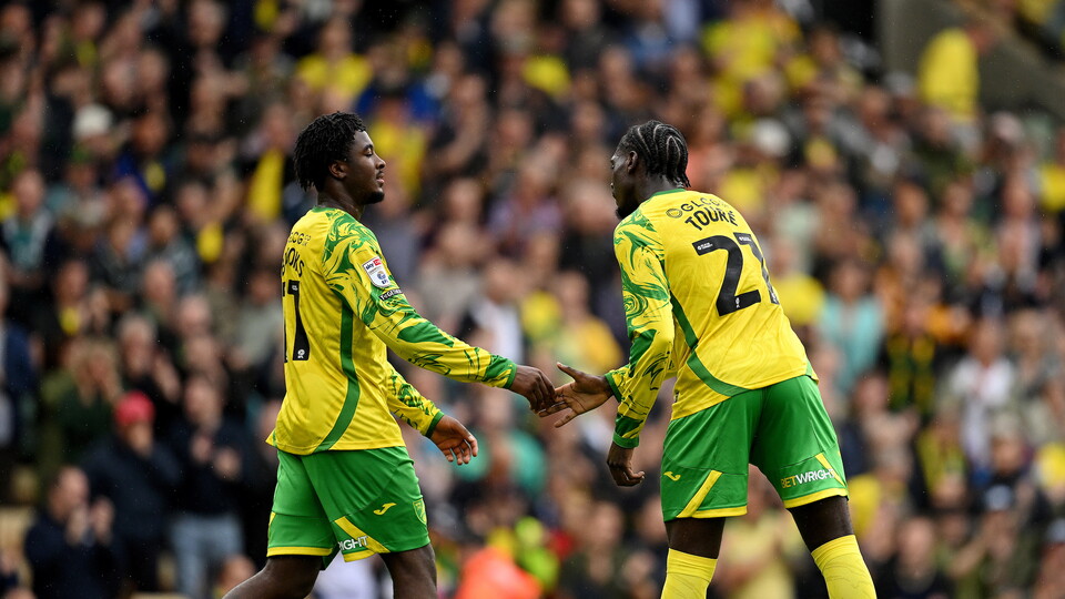 Mo Toure and Andre Brooks celebrate against Burnley at Carrow Road