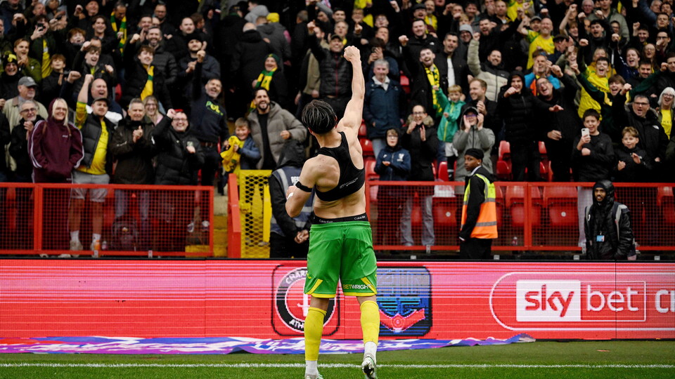 Jacob Wright celebrates with the Norwich City fans at The Valley