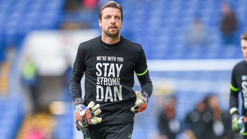 Norwich City are auctioning off the warm-up tops worn by first-team players prior to last weekend's match against Chelsea.
