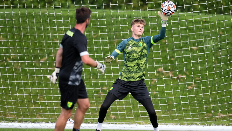 Norwich City goalkeeper Archie Mair has returned to the club following the end of his loan spell at Lincoln City.