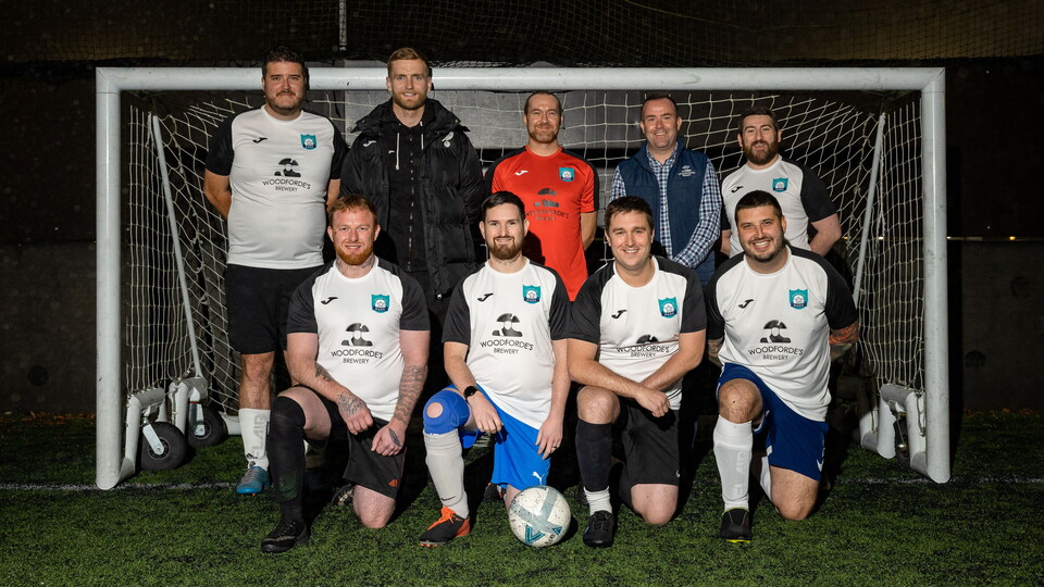 Norwich City goalkeeper George Long this week visited Match of the Dads, as they were presented with their new kit by Woodforde's Brewery.