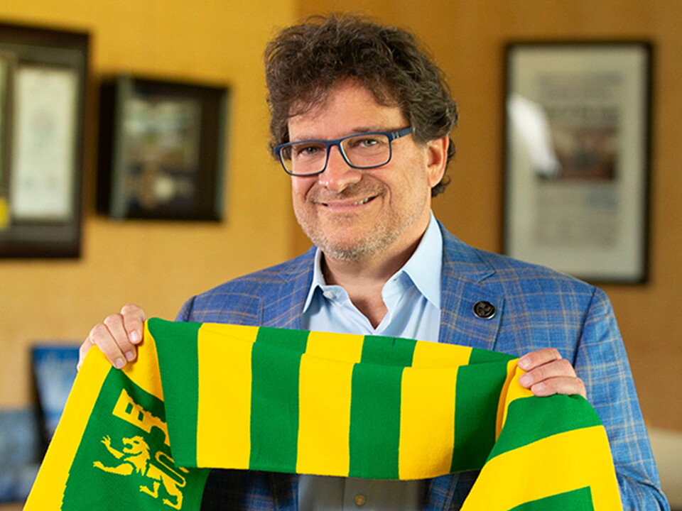 Mark Attanasio holding a Norwich City scarf